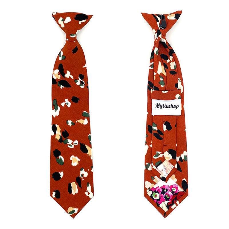 Boys Floral Clip On Tie Terracotta AUTUMN-Boys Floral Clip On Tie Material: Suede Approx Size: Color: Dark Terracotta Max width: 6.5 cm / 2.4 inches 9-24 months 26 CM2-5 years 31 CM9-11 Years 43 CM Add a pop of color to your little one&#39;s outfit with this Phoebe Boys Floral Clip On Tie. This tie is perfect for any formal occasion, whether it&#39;s a wedding or family gathering. The clip-on design makes it easy to put on and take off, and the 2.36&quot; size is perfect for toddlers and kids. The colorful f