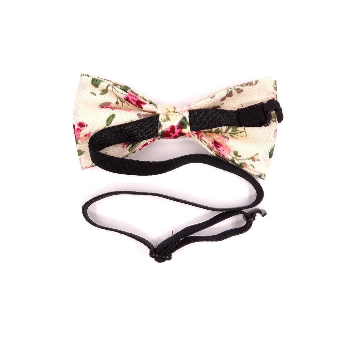 Cream Kids Floral Pre-Tied Bow Tie - EMMETT-Cream Kids Floral Pre-Tied Bow Tie Give your little one a dapper look with our EMMETT kids bow tie. This sweet floral bow tie is perfect for special occasions or just dressing up a everyday outfit. With a pre-tied design, it's easy to put on and take off, and it stays in place all day long. Whether you're dressing your son or daughter for a wedding or just want to add a touch of personality to their outfit, our EMMETT kids bow tie is the perfect option