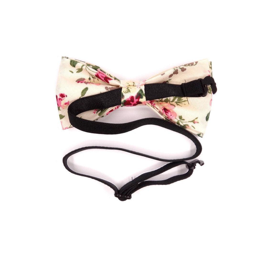 Cream Kids Floral Pre-Tied Bow Tie - EMMETT-Cream Kids Floral Pre-Tied Bow Tie Give your little one a dapper look with our EMMETT kids bow tie. This sweet floral bow tie is perfect for special occasions or just dressing up a everyday outfit. With a pre-tied design, it&#39;s easy to put on and take off, and it stays in place all day long. Whether you&#39;re dressing your son or daughter for a wedding or just want to add a touch of personality to their outfit, our EMMETT kids bow tie is the perfect option