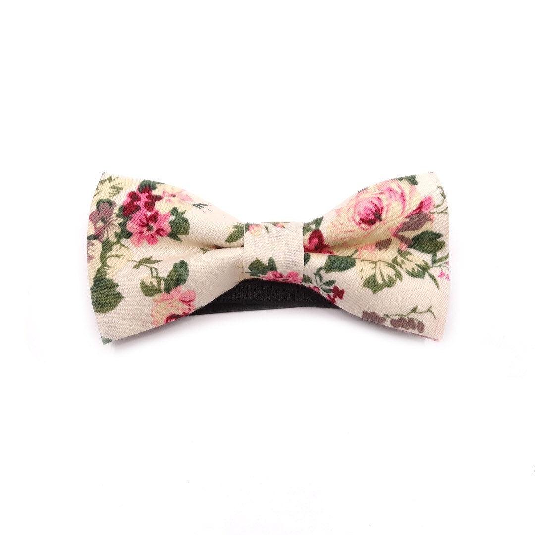 Cream Kids Floral Pre-Tied Bow Tie - EMMETT-Cream Kids Floral Pre-Tied Bow Tie Give your little one a dapper look with our EMMETT kids bow tie. This sweet floral bow tie is perfect for special occasions or just dressing up a everyday outfit. With a pre-tied design, it's easy to put on and take off, and it stays in place all day long. Whether you're dressing your son or daughter for a wedding or just want to add a touch of personality to their outfit, our EMMETT kids bow tie is the perfect option