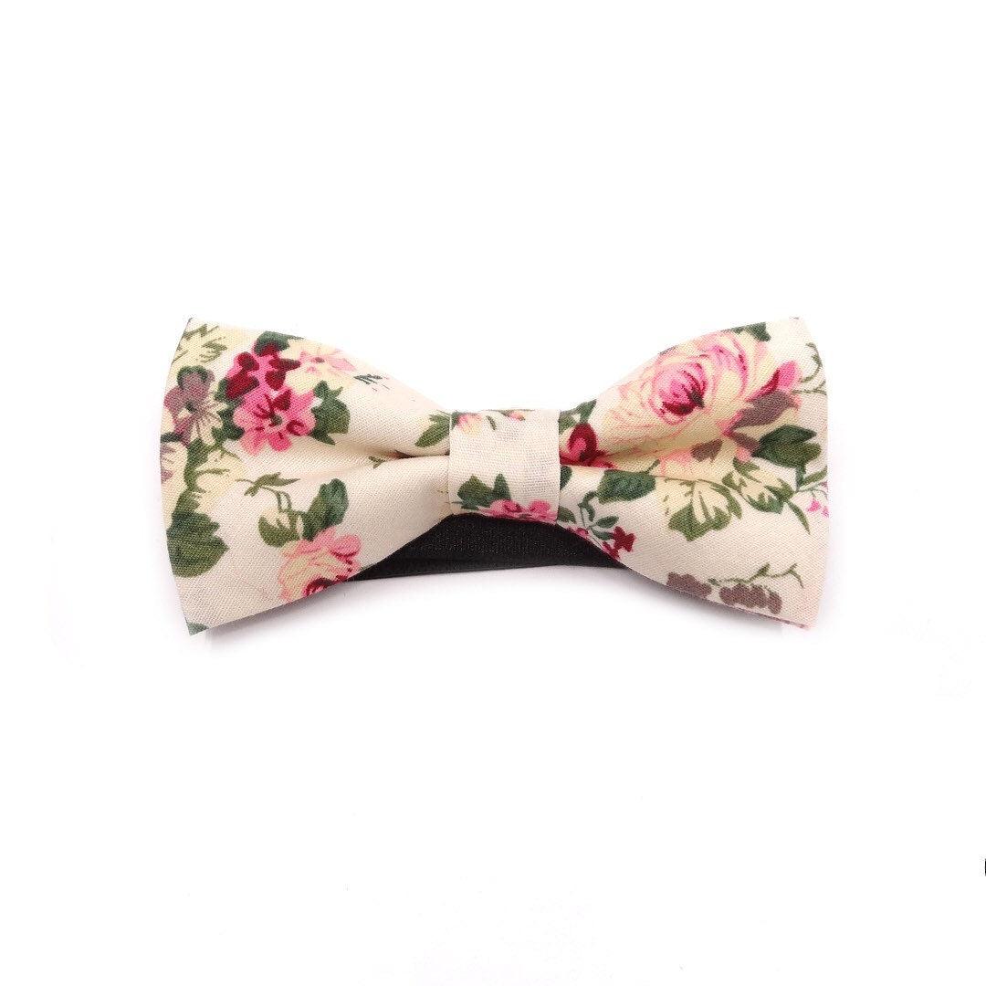 Cream Kids Floral Pre-Tied Bow Tie - EMMETT-Cream Kids Floral Pre-Tied Bow Tie Give your little one a dapper look with our EMMETT kids bow tie. This sweet floral bow tie is perfect for special occasions or just dressing up a everyday outfit. With a pre-tied design, it&#39;s easy to put on and take off, and it stays in place all day long. Whether you&#39;re dressing your son or daughter for a wedding or just want to add a touch of personality to their outfit, our EMMETT kids bow tie is the perfect option