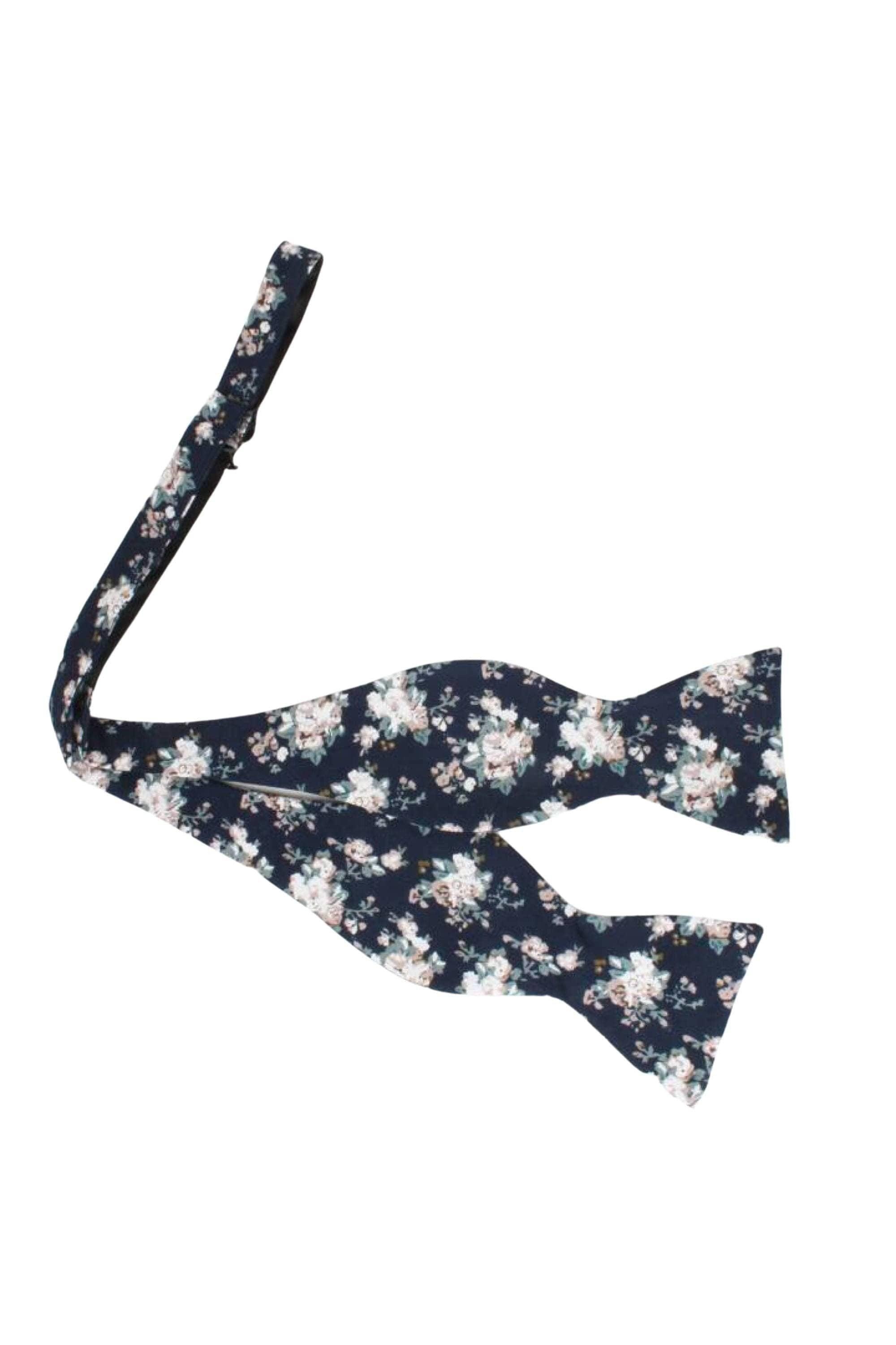 Navy Floral Bow Tie Self Tie FINLEY - MYTIESHOP Blue-Navy Floral Bow Tie 100% Cotton Flannel Handmade Adjustable to fit most neck sizes 13 3/4" - 18" Elevate your style and make a statement with this navy blue bow tie. With a versatile navy color and blue floral print, this bow tie is perfect for any formal event. Grooms, weddings, and formal affairs come to mind - but this bow tie can be dressed down for a more relaxed look as well. With a self-tie design, this bow tie is easy to put on and tak