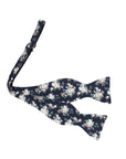 Navy Floral Bow Tie Self Tie FINLEY - MYTIESHOP Blue-Navy Floral Bow Tie 100% Cotton Flannel Handmade Adjustable to fit most neck sizes 13 3/4" - 18" Elevate your style and make a statement with this navy blue bow tie. With a versatile navy color and blue floral print, this bow tie is perfect for any formal event. Grooms, weddings, and formal affairs come to mind - but this bow tie can be dressed down for a more relaxed look as well. With a self-tie design, this bow tie is easy to put on and tak