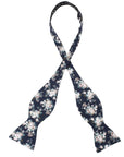 Navy Floral Bow Tie Self Tie FINLEY - MYTIESHOP Blue-Navy Floral Bow Tie 100% Cotton Flannel Handmade Adjustable to fit most neck sizes 13 3/4" - 18" Elevate your style and make a statement with this navy blue bow tie. With a versatile navy color and blue floral print, this bow tie is perfect for any formal event. Grooms, weddings, and formal affairs come to mind - but this bow tie can be dressed down for a more relaxed look as well. With a self-tie design, this bow tie is easy to put on and tak
