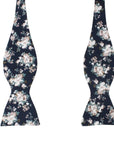 Navy Floral Bow Tie Self Tie FINLEY - MYTIESHOP Blue-Navy Floral Bow Tie 100% Cotton Flannel Handmade Adjustable to fit most neck sizes 13 3/4" - 18" Elevate your style and make a statement with this navy blue bow tie. With a versatile navy color and blue floral print, this bow tie is perfect for any formal event. Grooms, weddings, and formal affairs come to mind - but this bow tie can be dressed down for a more relaxed look as well. With a self-tie design, this bow tie is easy to put on and tak